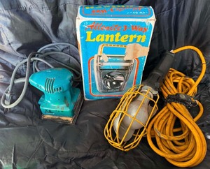 Lot of lantern, light, and sander