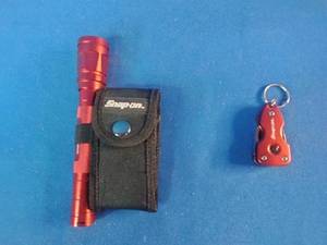 Snap-on brand red multi-tools and a matching flashlight.