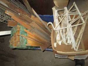 Plastic tote containing long wood d...