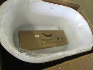Streamline bathtub, one edge has da...