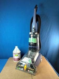 This upright cleaning machine is a Hoover Max Extract 60 Pressure Pro Carpet Deep Cleaner (Model FH50220). It is pictured next to a multi-purpose carpet cleaning formula