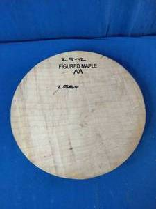 12  Circular wood blank intended for woodworking, woodturning, or musical instrument making.