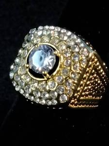Brand New This is a mens Pinky Ring yellow gold-plated ring featuring a large center stone surrounded by smaller simulated diamonds. Size 7