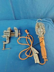 Pro-Grade 3 workshop clamp vise and an orange trouble work light.