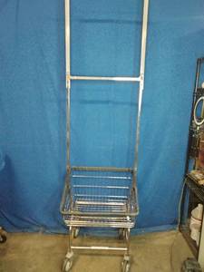 This is a R&B Wire Products commercial laundry cart with a clothes hanging rack.