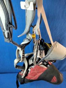 CAMP USA Flint Climbing Harness featuring EVA padding and auto-locking buckles, These are Adidas Five Ten Coyote climbing shoes with Stealth C4 rubber soles, and This is a ClimbX Fiend climbing chalk bag in green.
