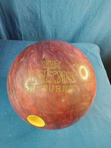 This is a 15 pound Dyno-Thane The Thing Returns bowling ball featuring a red and maroon swirl pattern