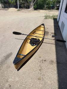 Wenonah Wee Lassie solo canoe featuring a lightweight hull and a kayak-style paddle.