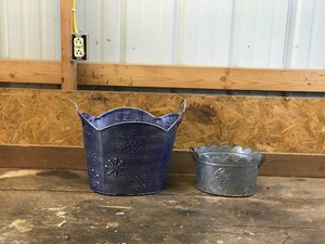 2 - Metal Baskets  One has roses on the side and the other has snow flakes