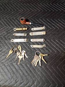 Vintage bottle openers, whistle, keys and a pipe