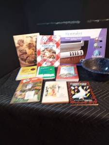 Lot of cookbooks, power control center, and enamelware colander,