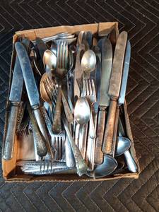 Large box of assorted silverware with set of tin measuring spoons
