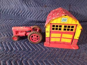 1950s Marx tin litho Magic Barn Automatic door garage and a plastic McCormick Farmall with hard rubber tires