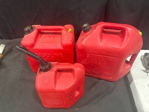 Three Red Plastic Gasoline Cans