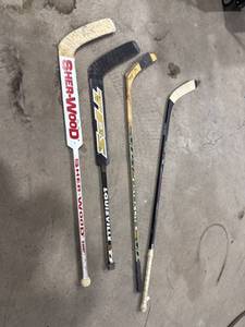 Four Used Hockey Sticks