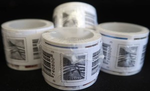 4 UNOPENED COILS OF FOREVER STAMPS.