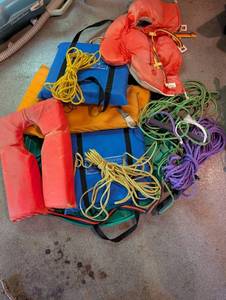 Personal flotation devices and throwable rescue lines