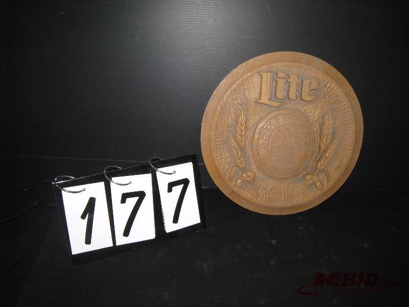 lot 177 image: Miller Lite - plastic - looks like carved wood 14 diam.