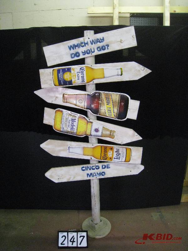 lot 247 image: Which way do you go wooden directional sign with 4 tin tackers Corona and Modelo beers 35 w x 74 h