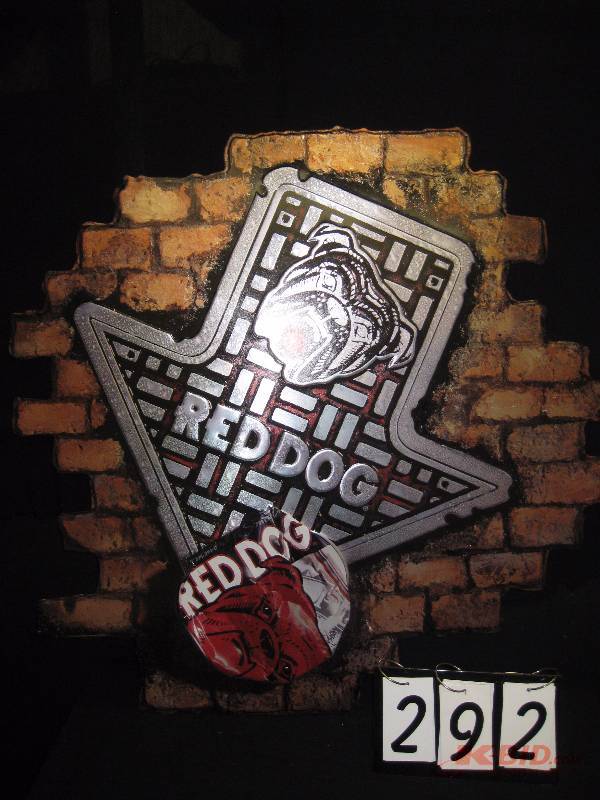 lot 292 image: Red Dog embossed tin tacker 39 w x 38 h