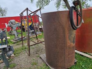 Fuel storage tank with pump and metal stand,  The tank measures approximately 39 inches in diameter and 63 inches in height - Approx. 300 gallon
