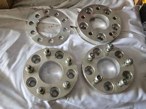 Wheel spacers including One  5x114.3-5x120.65 and Three  5-4.755-4.75 patterns, aluminum construction with bolt-on design.