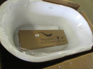 Streamline bathtub, one edge has damage