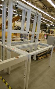 Steel frame, adjustable height workbench with laminate top and wired with electrical outlets 120V plugs