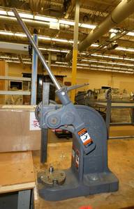 DAKE Arbor press 1-12 Ton mounted on a 72x36 workbench with wood top and steel legs, adjustable height