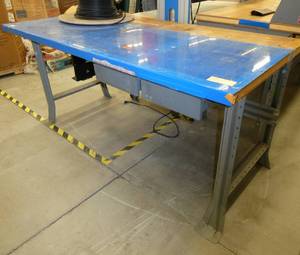 72x36 Workbench with wood top and steel legs, and a couple of drawers, top is covered with a plastic