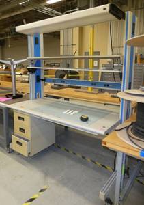 lab workbench with multiple electrical plugs and overhead light