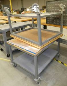 Two 30x38 rolling tables with wood top and steel base