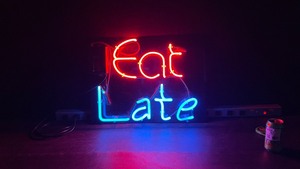 Eat Late neon on black plexi background