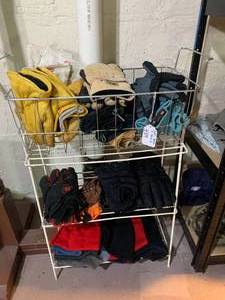 Small metal shelf with work gloves ...