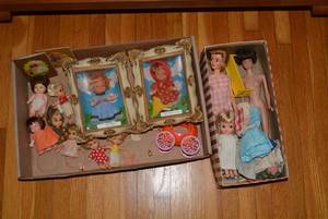 Dolls and doll clothes all on bott...