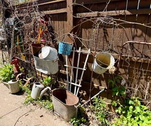Large Group of Primitive Antique Items - 2 Gates, Watering Cans, Cast Iron Pump etc