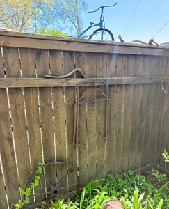 Contents of Fence - Cast Iron Wheel &amp other Items - Old Tricycle etc