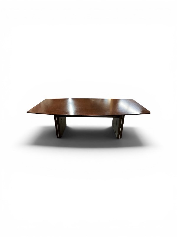 Modern Boat-shaped Conference Table featuring a dark wood finish and a sturdy pedestal base with vertical accents