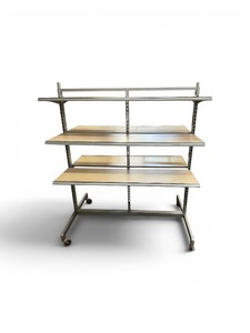 retail merchandising island gondola display unit featuring a chrome steel frame and wood-finished shelving
