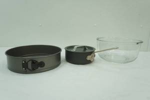 spring form cheesecake pan, glass mixing bowl, small pot with lid