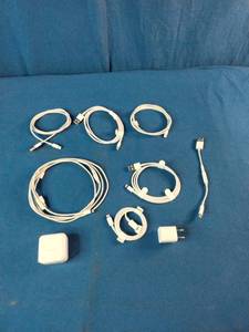This is a mixed lot of Apple branded white charging cables and power adapters.