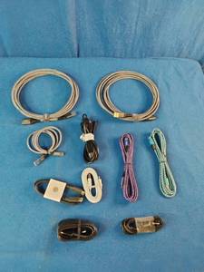 Ten assorted electronic data and charging cables organized against a solid blue background.