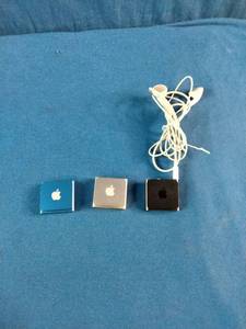 (3) Apple iPod Shuffle 4th Generation devices, known for their ultra-compact design and built-in clip.