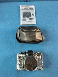 Brand New Vintage 1980s Cortland CX-7 35mm film camera, packaged with its original manual and black carrying case.