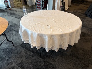Multiple white linens for round banquet tables