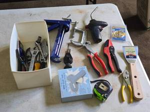 Lot of (1 Tub) Assorted Hand Tools - Caulk Gun, C-Clamps, Ratchet and Sockets, Adjustable Wrench, Tongs, Scraper, Pliers, Tape Measure