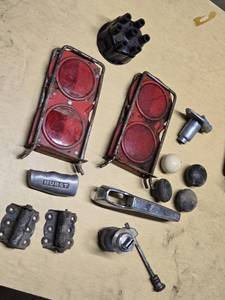 Assorted Vintage Automotive Parts including Hurst Shifter Handle, Reflecters, Hinges, and Distributor Cap