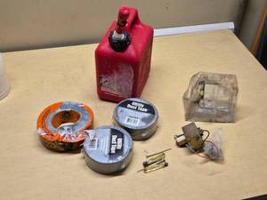 Red Plastic Gas Can, Rolls of Utility Duct Tape, and Small Tools Assortment
