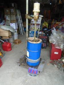 Graco grease pump & 30 gallon tub of grease half full. As shown.