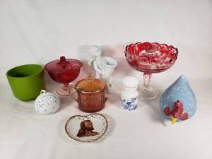 Assorted Glass and Ceramic Home Decor Items including Red Glass Compote, Blue Rooster Figurine, and Heart-Shaped Plate with Religious Image